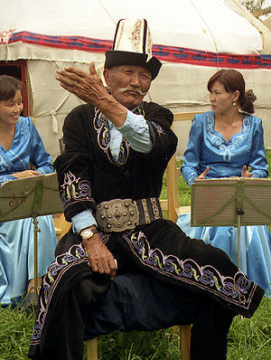 A traditional Kyrgyz manaschi performing part ...